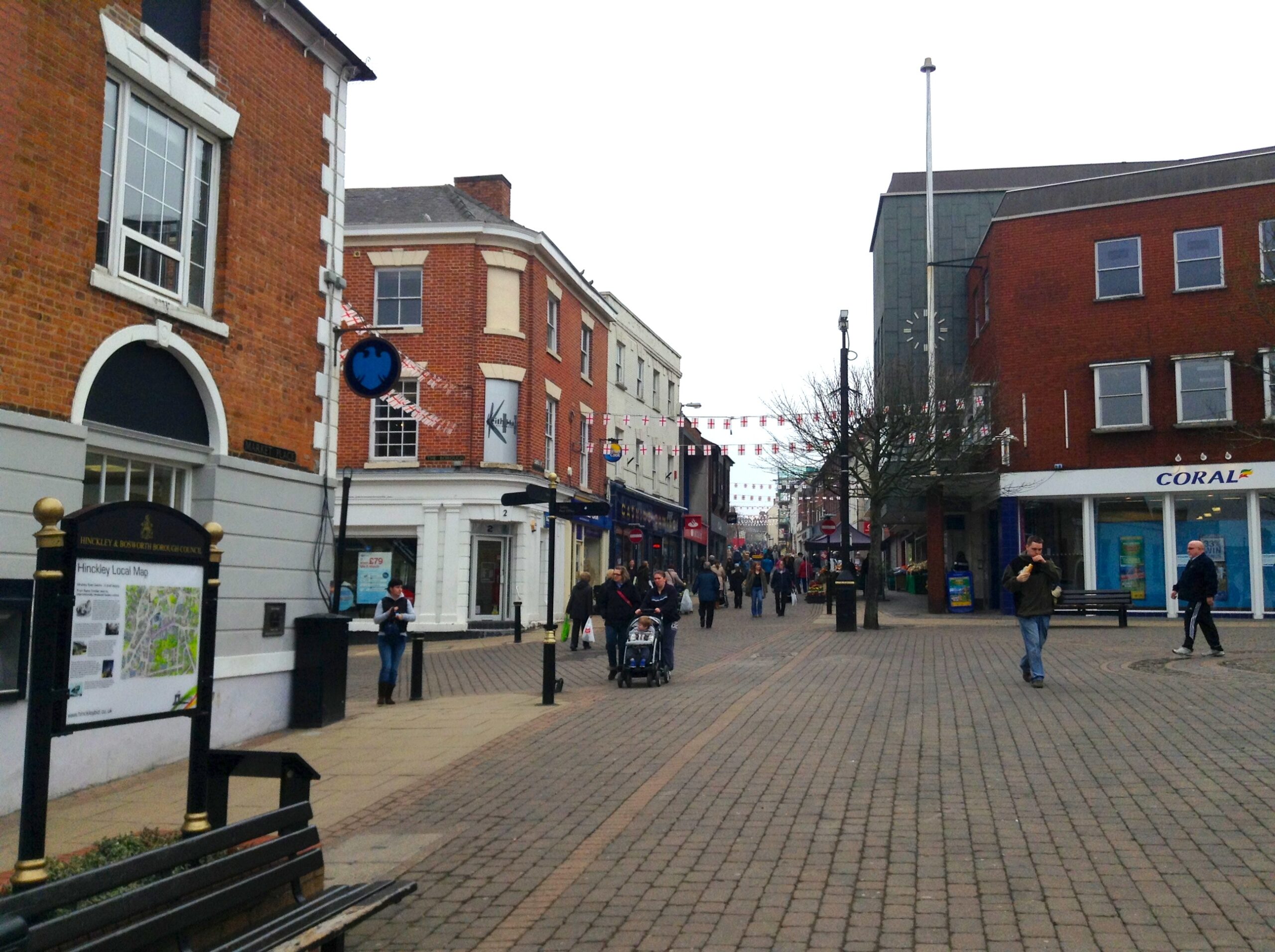 Hinckley town centre with bustling shops and people.