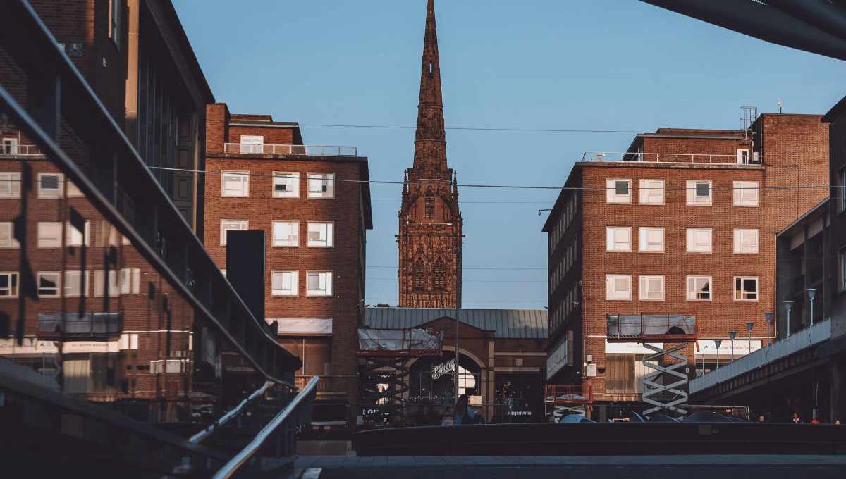 Historic tower between modern brick buildings