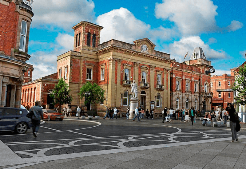 People outside historic building on sunny day.