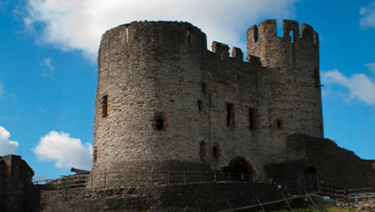 Historic stone castle under blue sky.